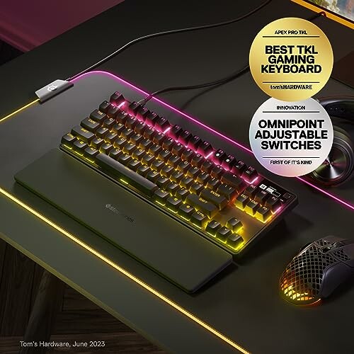 Colorful gaming keyboard and mouse setup with awards.