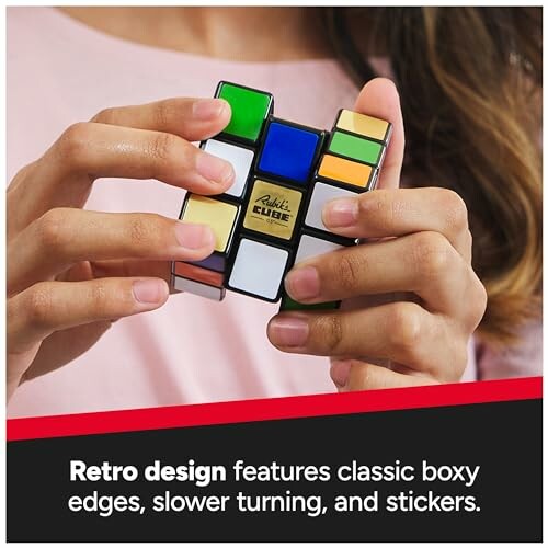 Hands holding a retro Rubik's Cube with classic design.